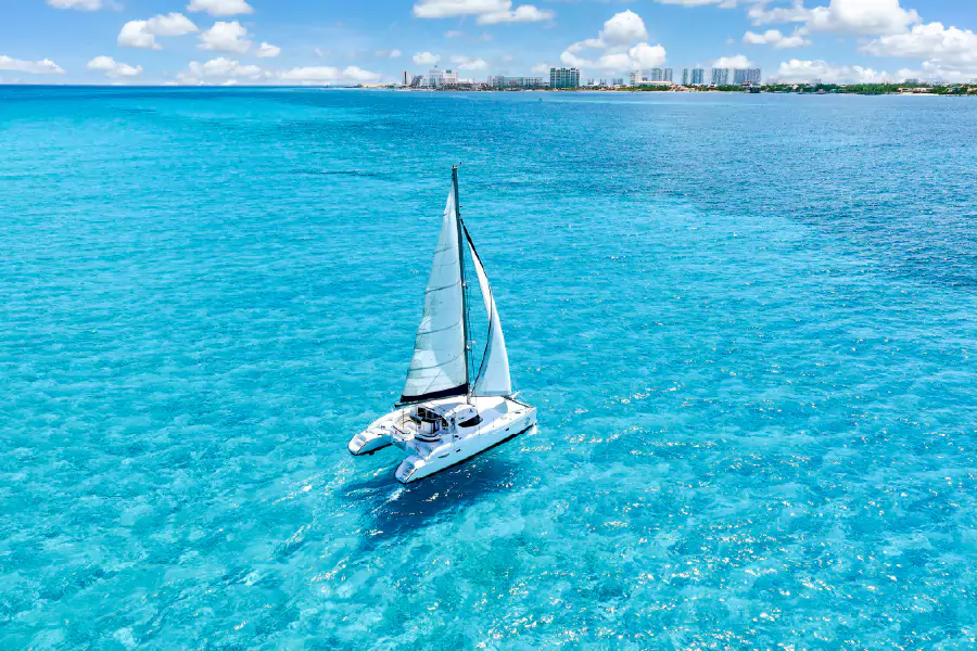 cover Premium Catamaran tour to Isla Mujeres with transportation & Dock fee Included